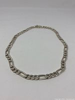 Full view of the 18-inch heavy link chain laid flat, showing alternating link style and clasp position.