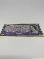 Full front side of the 1954 ten dollar bill showing design, serial number, and portrait of Queen Elizabeth II.