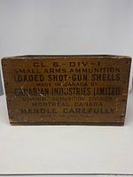 Front view of wooden crate with black stencil text indicating contents as small arms ammunition and loaded shotgun shells, made in Canada by Canadian Industries Limited, Montreal.