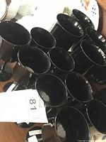 Photo showing a group of black stemmed glasses from a top angle.