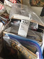 Box filled with various comic books including visible title The Savage Sword of Conan stored in plastic bags