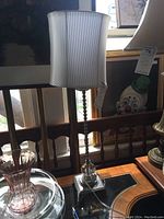 Front view of the tall lucite and metal floor lamp showcasing the textured, sparkly white shade and twisted metal column base.