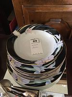 Stack of Mikasa Charisma china plates and a bowl showing floral design and gold trim