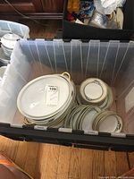 Photo showing a large plastic bin filled with various Noritake Malvern china pieces including plates, bowls, and serving pieces.