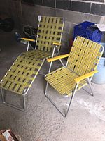 Overview of both chairs: one reclining lounge chair with footrest and one upright lawn chair
