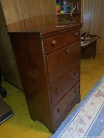 Front and side view of the wooden dresser with pull down secretary door showing overall condition and shape.