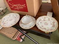 Side plate, tea cup and saucer arranged on table showing pattern