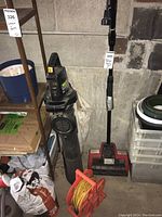 Photo of Noma TurboShovel, Weed Eater Groundsweeper Extreme leaf blower, and extension cord on caddy clustered together in garage area.