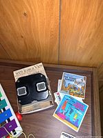 View-Master viewer on box with picture reels The Road Runner and Mary Poppins cards shown