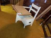 Full side view of the vintage white-painted wooden child's desk showing laminate top with pencil grooves and side storage drawer with metal handle.
