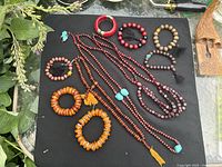 Assorted bead jewellery laid out on mat