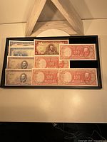 Fronts of assorted Banco Central de Chile notes in display tray