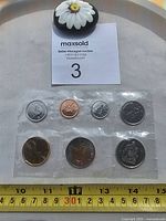2012 seven-coin set obverse sides in sealed plastic