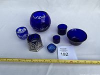 All eight items lined up with ruler for scale