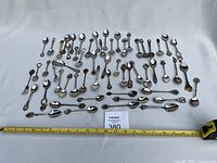 overview of all spoons and fork with measuring tape for scale