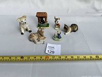 All six animal figurines front view with ruler for scale