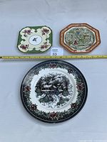 Group shot of three decorative plates with tape measure for scale