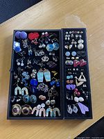 Overall view of both tray inserts showing entire assortment of earrings