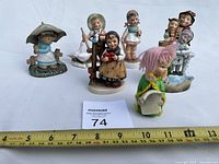 Group of seven child figurines front view