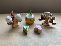 Full view of rooster with egg shakers, mustard jar, squirrel set on stand, cheese shakers