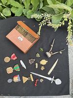 overview of entire lot on black fabric, showing ammunition pouch, medals, patches, pins, pipe and letter openers