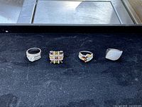 four rings side by side on black surface