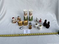 Entire group of salt and pepper shakers with measuring tape
