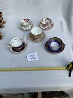All five teacup and saucer sets on white backdrop