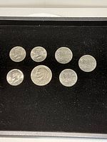 Obverse sides of all seven coins