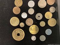 All coins spread on black background, obverse sides visible