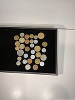 Overview of coin assortment on black tray