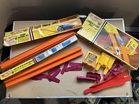 Overall view of track pieces, accessories and both Hot Wheels boxes