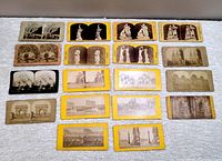 Photo showing 20 stereoscope viewer photo cards with images of sculptures and European landmarks arranged neatly on a white cloth surface