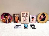 Full lot arranged showing two collectible plates, books, playing cards, and photo cards all themed on Elvis Presley