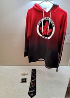 Red to black gradient medium hoodie with large Reel Canadian Anglers logo on the front and sleeve text.