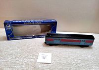 Photo of the diecast Lionel Polar Express streamliner passenger train car beside its box.