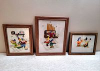 Three framed vintage needlepoint artworks featuring Disney Seven Dwarfs, varying sizes, arranged side by side showing overall visuals and frames.