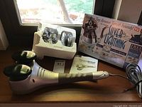 Therapist Select Wave Action Massager alongside Silver Lightning tarnish remover box and components on a wooden surface.