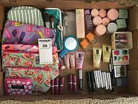 Full view of the box showing all Clinique skincare and makeup samples with cosmetic bags included