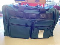 Green tackle bag closed on table