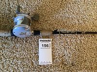 Fishing rod with cork handle and Kokanee Gold Seeker label, including attached reel and MaxSold lot tag