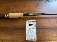 Close-up of Lamiglas fishing rod handle and model info G1213 printed on black rod near the grip.