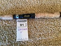 Close-up of cork handle and black reel seat showing Lamiglas branding.