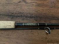 Fishing rod labeled 'Seeker 7GSP 704' showing cork handle section.