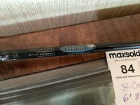 Close-up of St. Croix AVID fishing rod model and specifications on black graphite blank.