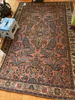 Overall top-down view of full rug on hardwood floor.