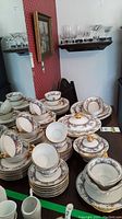 Overview of stacked plates, cups and saucers on table