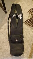 Burton snowboard bag in black with front zippered pocket and logos