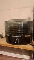 Front view of Elite Gourmet 6-tier food dehydrator showing trays and control dial.