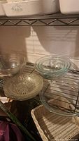Three clear glass bowls including one with textured bottom and two smooth ones stacked